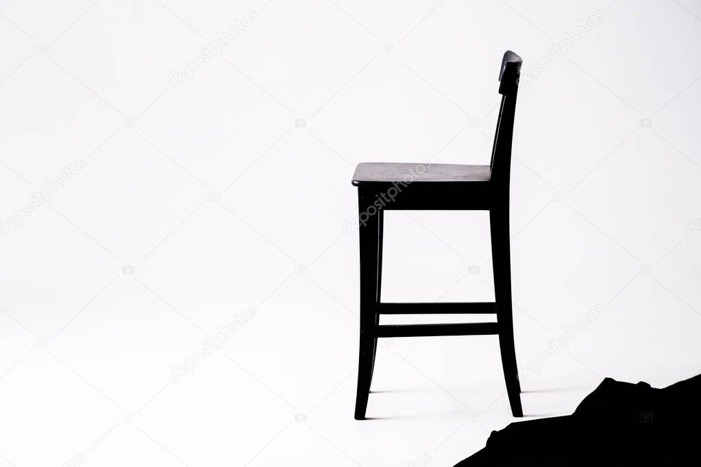 black chair on white background, in white room 