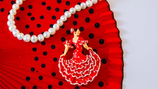 miniature figure of a dancer in combination with women's things-fan, lipstick, perfume, beads