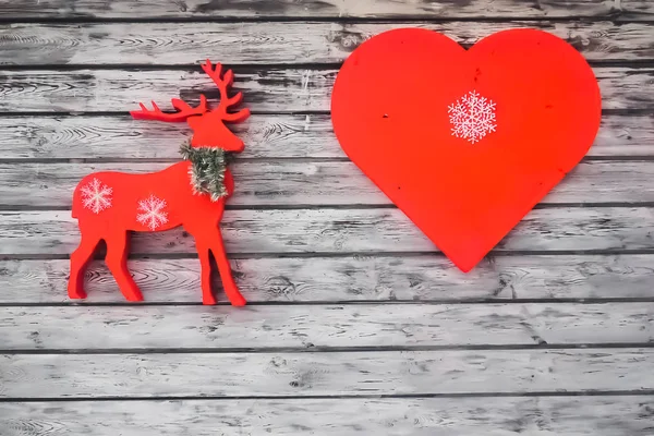 heart-a symbol of love and red reindeer-a symbol of winter
