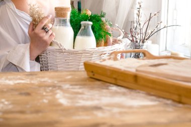 Şişelenmiş süt ve otlarla dolu mutfak masası. 