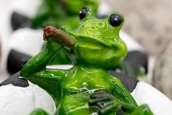 ceramic green frog in a frivolous pose