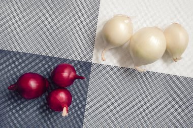 Arka planda kırmızı soğan ve beyaz soğan dört parçaya bölünmüş. 