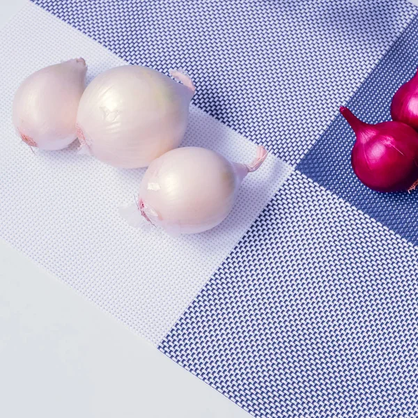 red onion and white onion on a background divided into four parts