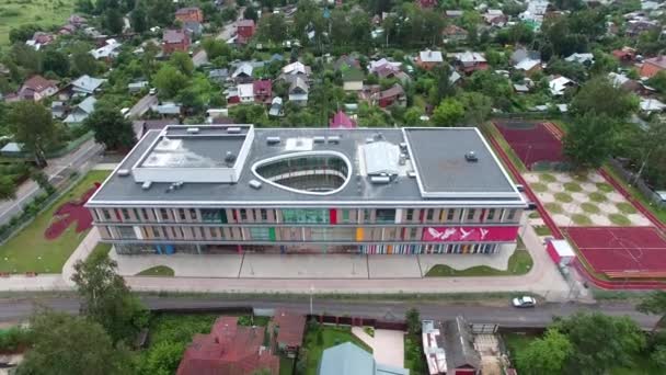 Pusta tęcza piękna nowa nowoczesna szkoła w małej wiosce. wiev z powietrza — Wideo stockowe