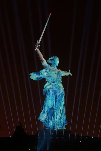 Sculpture the Motherland on Mamayev Kurgan in blue light during the show Light of the Great Victory 2018 of year
