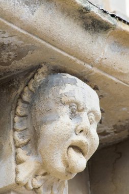 Mascarons, Sicilya'daki Syracuse eyaletinde bir barok saray balkon altında komik yüzü olan görünümünü portre