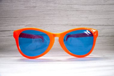 Gri ahşap masada moda güneş gözlükleri. Klasik renk biçimi.