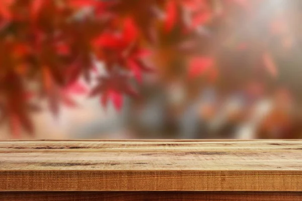 Ahşap masa ve bulanıklık sonbahar orman arka plan.