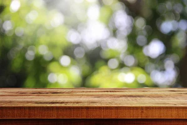 Wooden Desk Blurred Green Bokeh Background — 스톡 사진