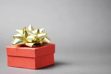 Gri arka planda Noel kırmızı hediye kutusu.