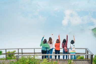 grup Asyalı kadın gezgin bahar mevsiminde dağın zirvesinden 2020 ile güneşin doğuşunu ve parmağını göster