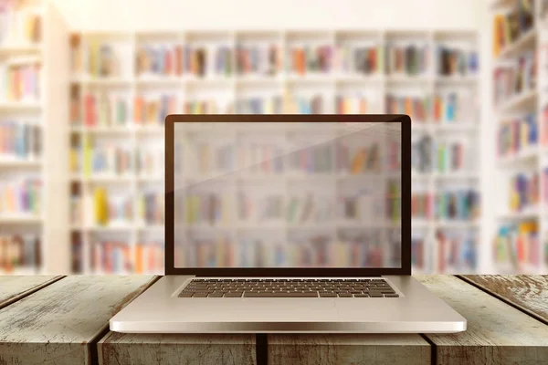 Laptop with with screen against teacher reading books to her students