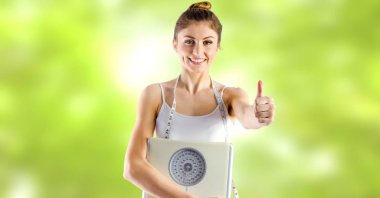 Digital composite of Woman holding weighing scales in Summer clipart