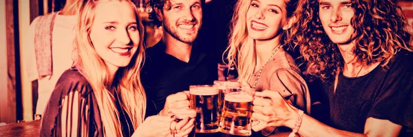 Portrait Happy Friends Toasting Beer While Standing Counter Nightclub — Stock Photo, Image