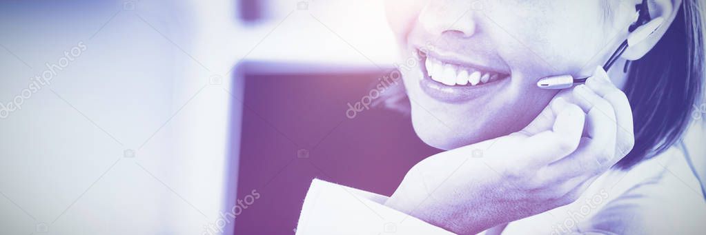 Cute businesswoman talking with clients in front of her computer in the office