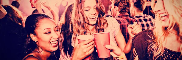 Female Friends Toasting Disposable Cups While Enjoying Music Nightclub — Stock Photo, Image