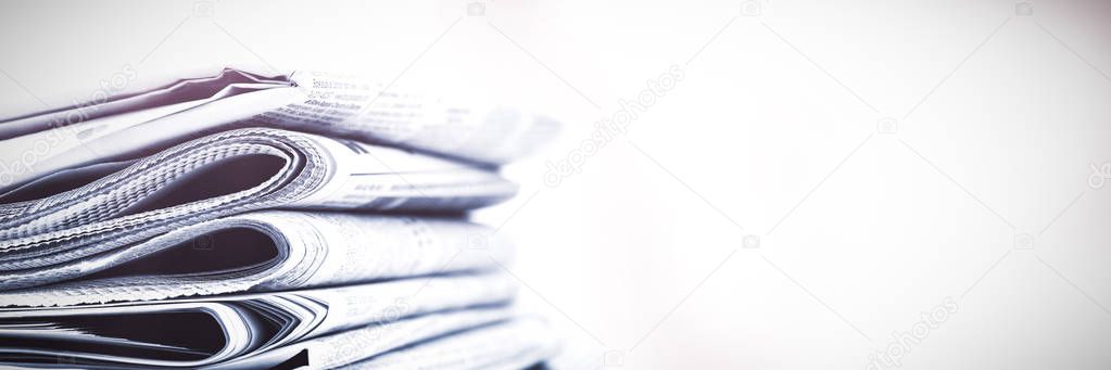 Stacks of newspapers against white background