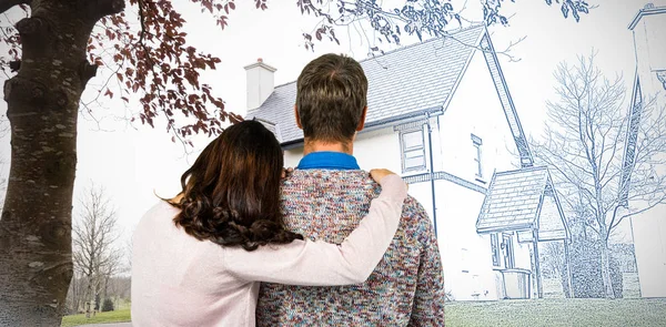 Rear view of couple standing against image of house and pretty house with a blue and white filter