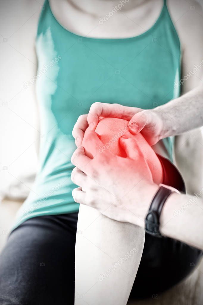 Emerging man doing fitness exercises with a woman against highlighted pain