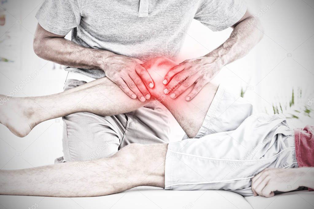 Highlighted pain against male physical therapist massaging patient knee