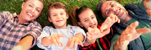 Famiglia Felice Sdraiata Sull Erba Fare Gesti Mano Nel Parco — Foto Stock