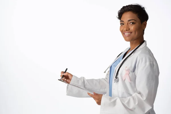 Smiling Female Doctor Wearing Breast Cancer Awareness Pink Ribbon Writing — Stock Photo, Image