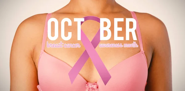 Breast cancer awareness ribbon with text against woman in pink bra