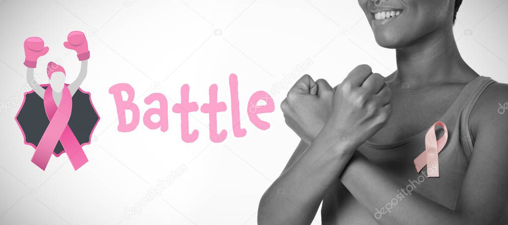 Battle text with female likeness and breast cancer awareness ribbon against smiling woman crossing arms