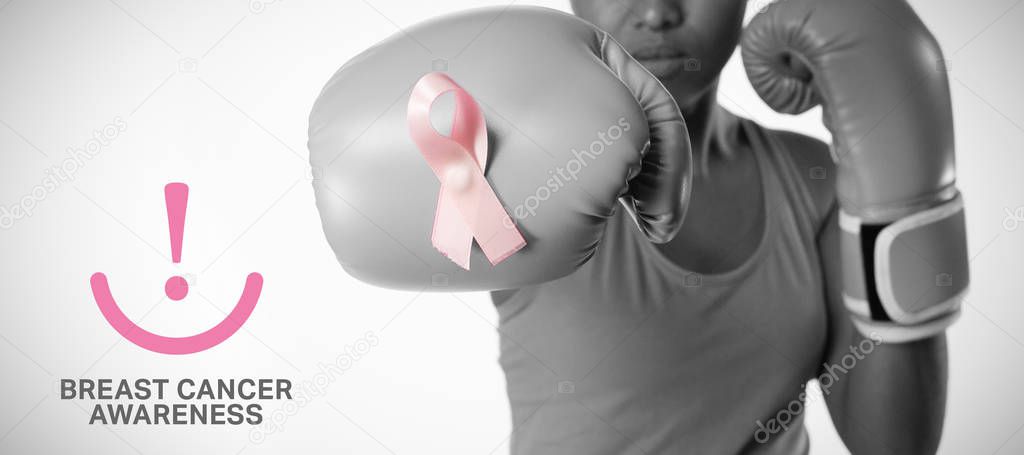 Breast cancer awareness message against woman in boxing gloves