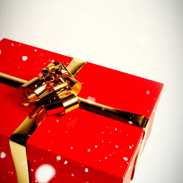 Snow Falling Christmas Gift Golden Bow — Stock Photo, Image