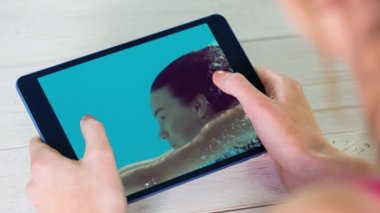 Dijital tablet ekran Close-up bir kadın havuzda gösterir