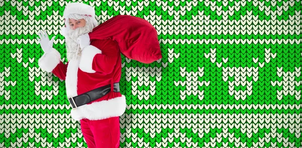 Bir Torba Tutarak Beyaz Yeşil Desen Karşı Sallayarak Santa — Stok fotoğraf