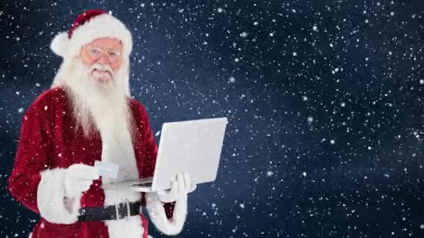 Composto Digital Santa Cláusula Segurando Laptop Combinado Com Queda Neve — Vídeo de Stock