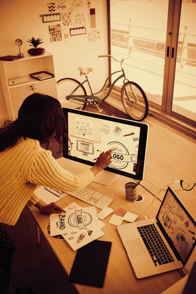 High angle view of female graphic designer working in creative office