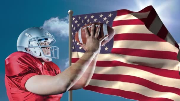 アメリカ国旗に対してラグビー ボールを持って立っているラグビー選手のデジタル アニメーション アメリカの国旗を背景に風に揺れる — ストック動画