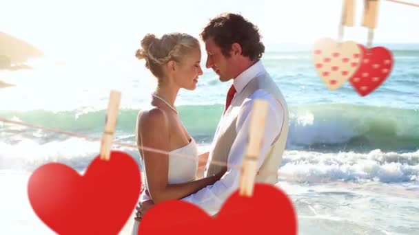 Young Couple Smiling Wedding Beach Hearts Forefront — Stock Video