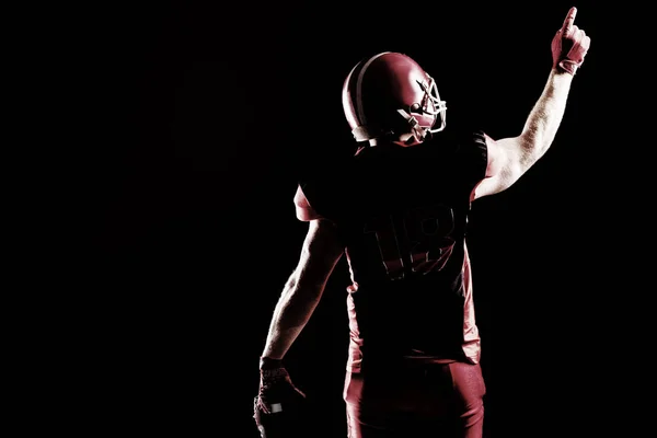 ヘルメットは上向きでアメリカン フットボール プレーヤーの背面図 — ストック写真