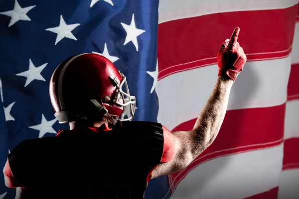 美国足球运动员在头盔指向向上对美国国旗的特写镜头 — 图库照片