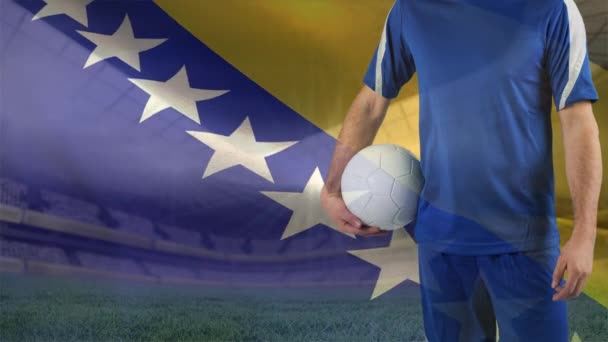 ボスニア ヘルツェゴビナの旗の背景を振ってに対してサッカーを保持しているサッカー選手のデジタル合成 — ストック動画