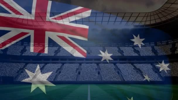 澳大利亚国旗挥舞着在风对足球场背景在一个阳光明媚的日子 — 图库视频影像
