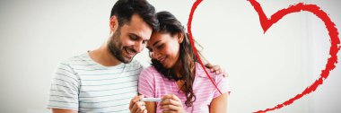 Kalp neşeli çift yatak odasında bir hamilelik testi sonuçlarını bulma karşı