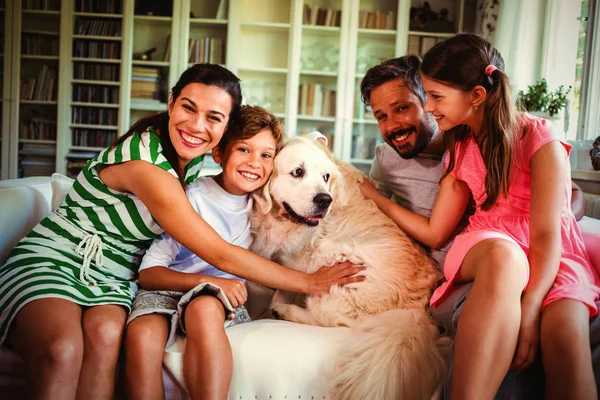 家庭与狗坐在沙发上的客厅在家里 — 图库照片