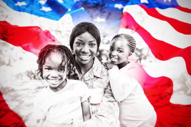 Close-up of wrinkled American flag against portrait of mother and children at park clipart