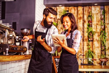 Bardaki kahve makinesi ile bir tablet bilgisayar ve garson kullanarak garson
