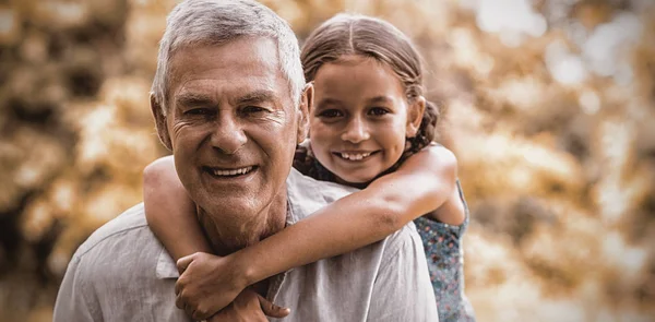 Smiling Grandfather Carrying Granddaughter Yard — Stock Photo, Image