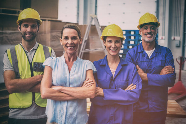 Workers team crossing arms in warehouse