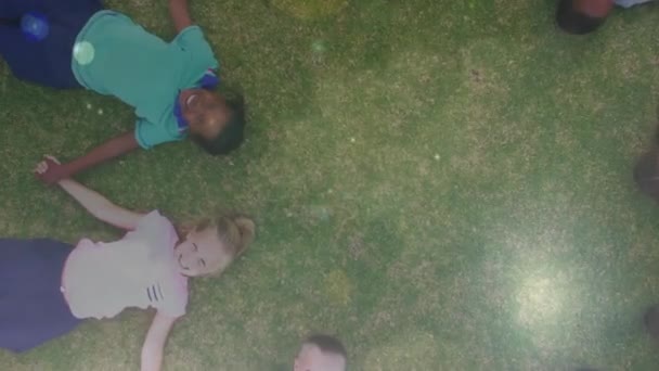 Composto Digital Crianças Deitadas Grama Mãos Dadas Estádio Futebol — Vídeo de Stock