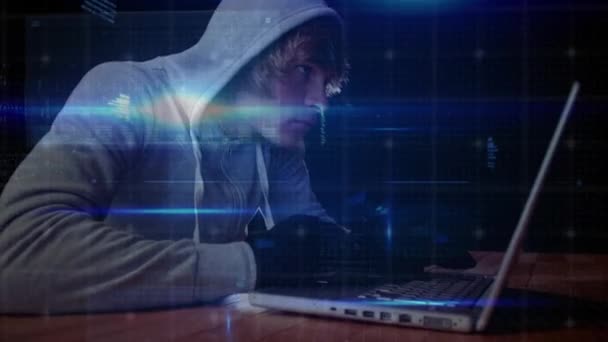 年轻的高加索黑客使用笔记本电脑的数字复合对在深蓝色房间的虚拟数据的说明 — 图库视频影像