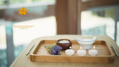 Dijital bileşik huzurlu bir tepsi yanan mumlar, lavanta ve deniz tuzları ile görüntünün. Animasyon Lotus ekrana geliyor