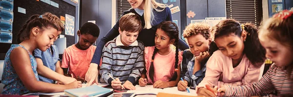 Lehrerin Hilft Schülerin Bei Hausaufgaben Klassenzimmer — Stockfoto